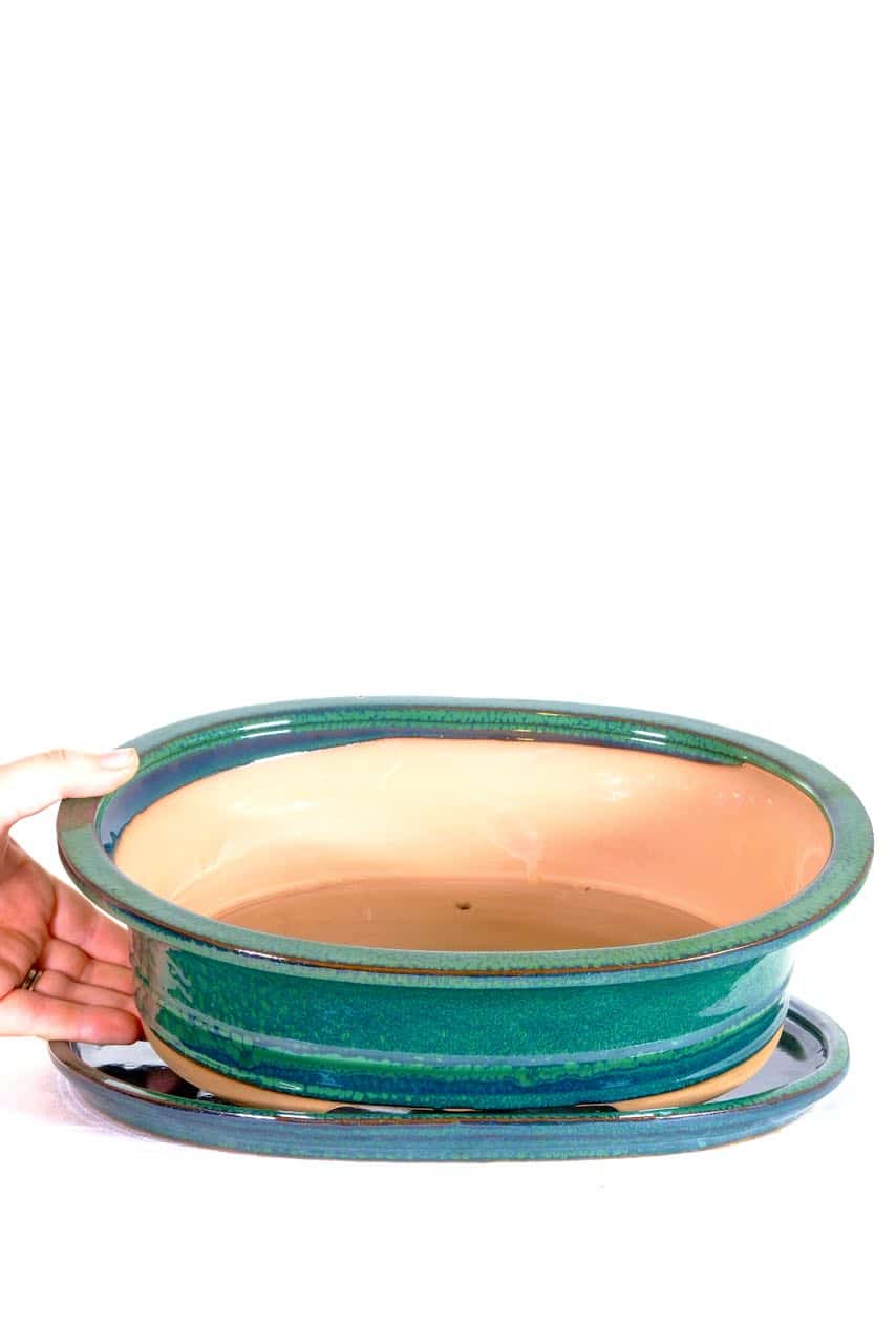 Forest green pot with ceramic tray and potting accessories